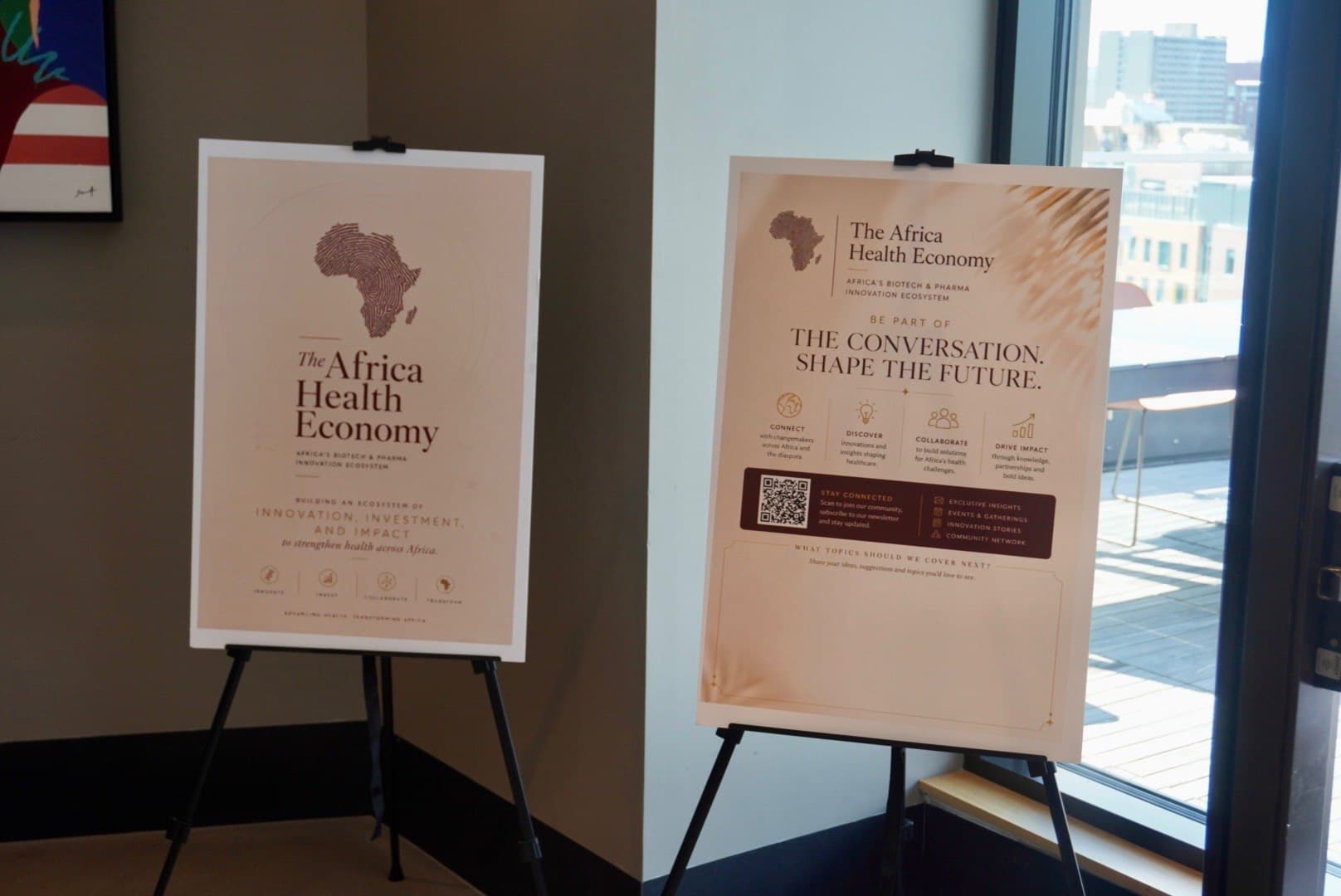 Flags, refreshments, and Africa Health Economy signage at The Golden Hour